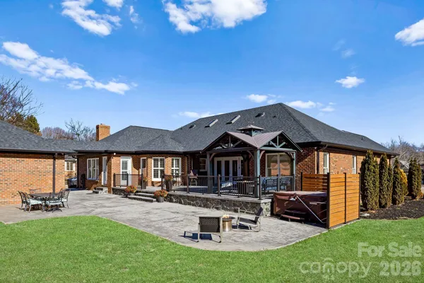 a view of a house with backyard and sitting area