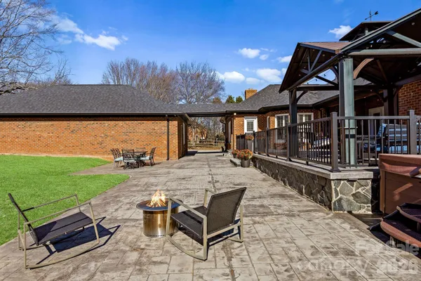 a view of a roof deck with couches and wooden floor