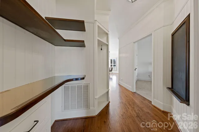 a view of hallway with wooden floor