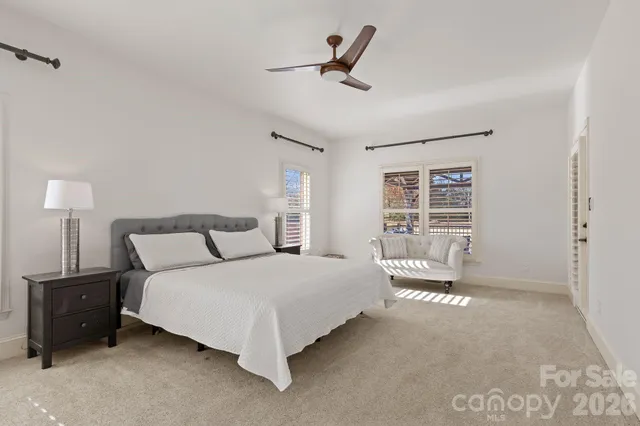 a bedroom with a bed a dresser and a window