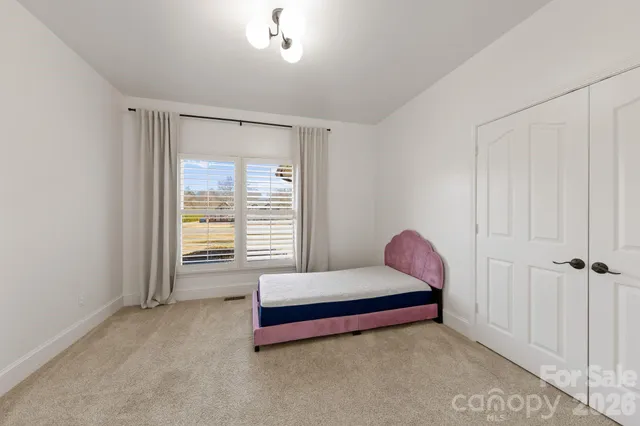 a room with a bed and a window