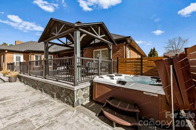 a view of a roof deck with couches and wooden floor