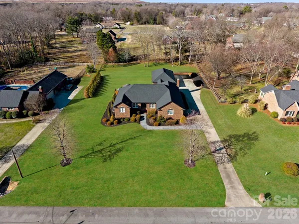 an aerial view of a house with a garden and swimming pool