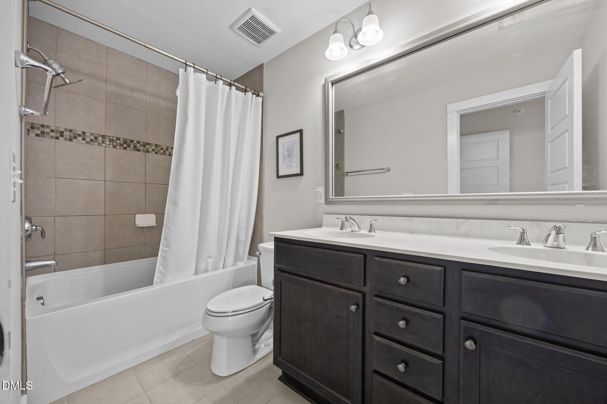 2791 Stone Rock Drive, Unit 113 Raleigh, NC 27604 - Photo 12 of 25 a bathroom with a double vanity sink toilet mirror and shower