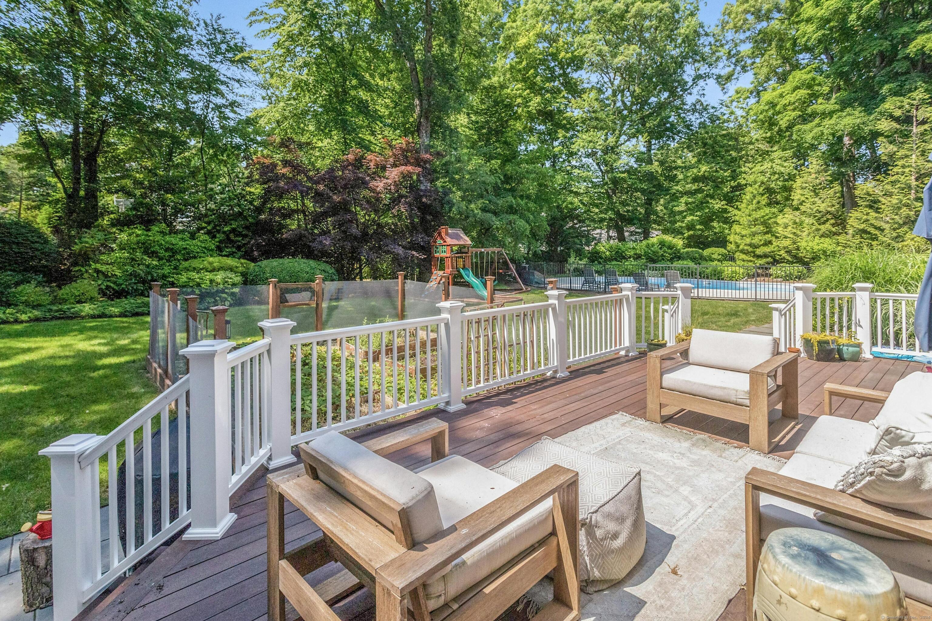 21 Roxbury Lane Wilton, CT 06897 - Photo 32 of 37 The back deck for entertaining or relaxing and enjoying nature the easy way. It looks over all the backyard has to offer including fenced gardening beds.