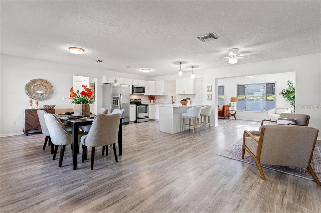 7370 Holiday Drive Spring Hill, FL 34606 - Photo 4 of 9 a view of a dining room with furniture and wooden floor