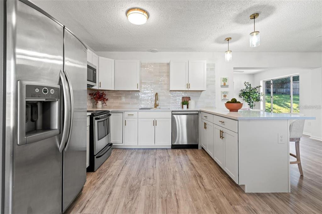 7370 Holiday Drive Spring Hill, FL 34606 - Photo 5 of 9 a kitchen with cabinets a sink and appliances