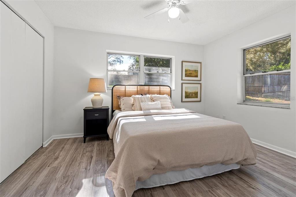 7370 Holiday Drive Spring Hill, FL 34606 - Photo 7 of 9 a bedroom with a bed and wooden floor