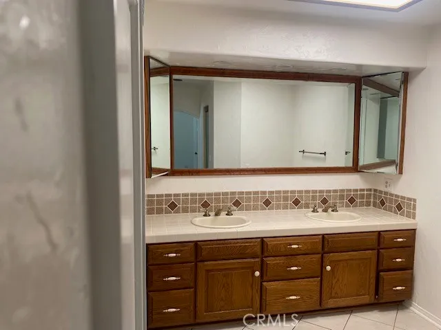 a bathroom with a sink vanity and mirror