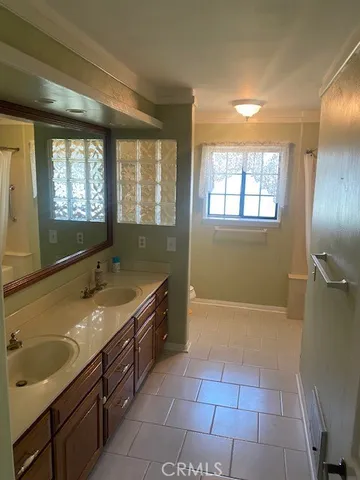 a bathroom with a granite countertop sink a mirror and a bathtub