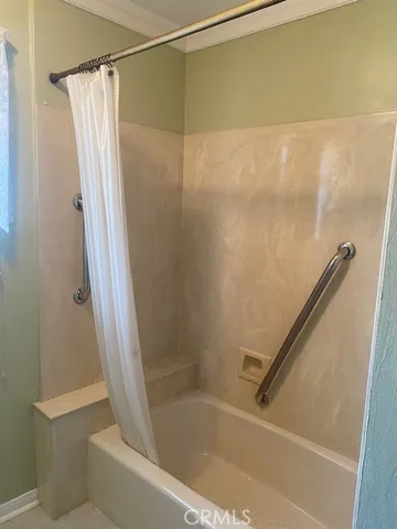 a bathroom with a shower and a bath tub