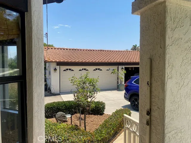 a view of a house with potted plants