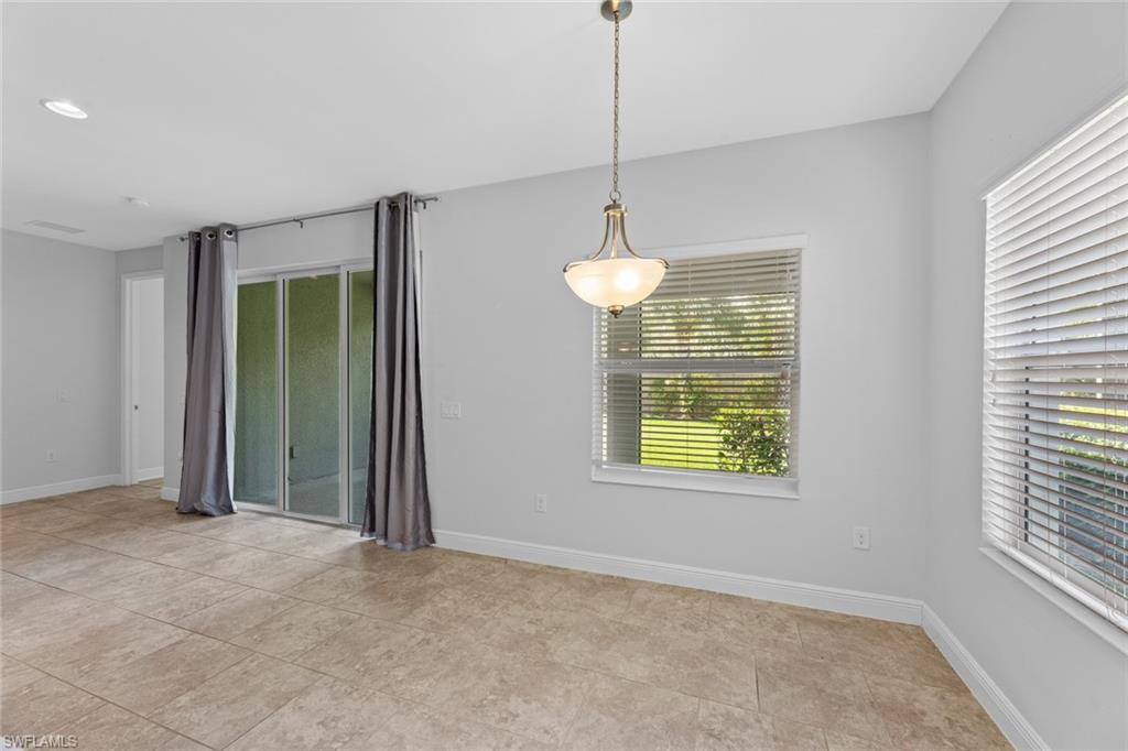 3711 Canopy Circle Naples, FL 34120 - Photo 11 of 28 a view of an empty room with a window and chandelier fan