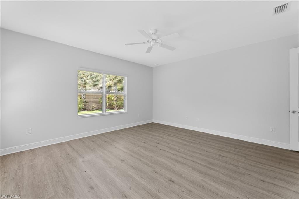 3711 Canopy Circle Naples, FL 34120 - Photo 20 of 28 wooden floor in an empty room with a window