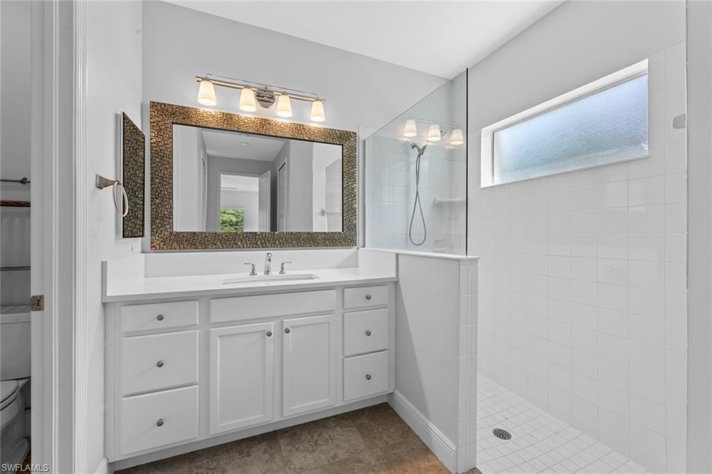 3711 Canopy Circle Naples, FL 34120 - Photo 22 of 28 a bathroom with a double vanity sink and mirror