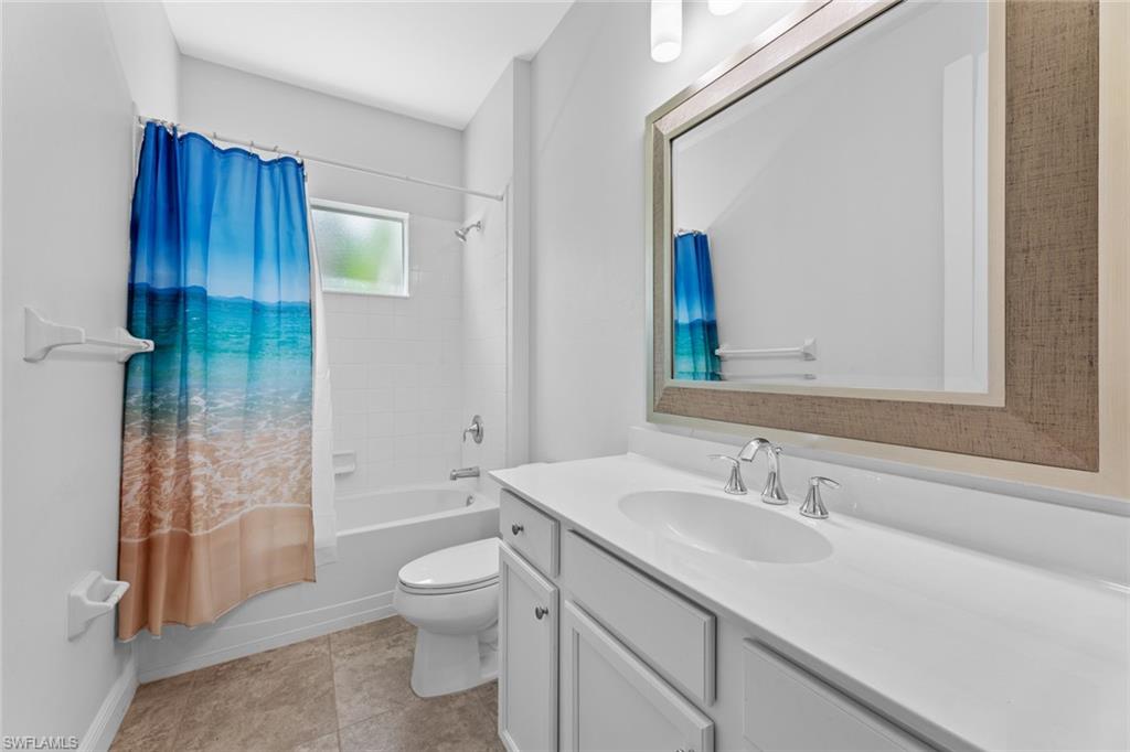 3711 Canopy Circle Naples, FL 34120 - Photo 23 of 28 a bathroom with a granite countertop sink toilet and shower