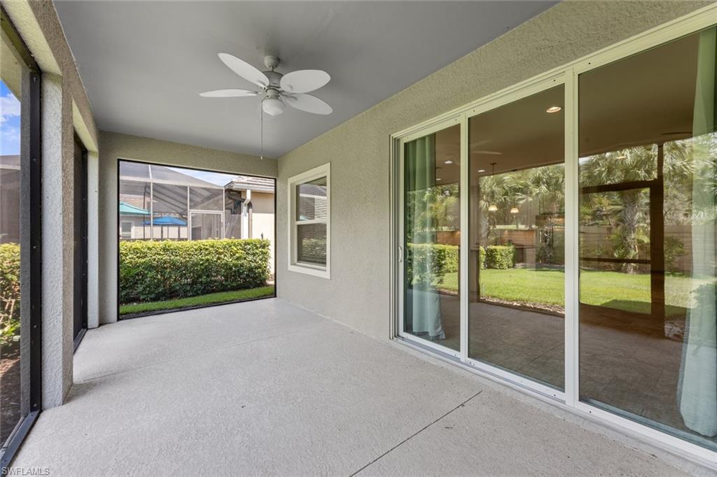 3711 Canopy Circle Naples, FL 34120 - Photo 26 of 28 a view of a livingroom with a ceiling fan and a large window