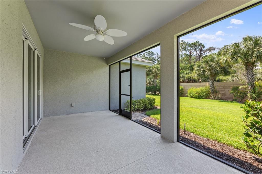 3711 Canopy Circle Naples, FL 34120 - Photo 27 of 28 a view of a big room with floor to ceiling windows and garden