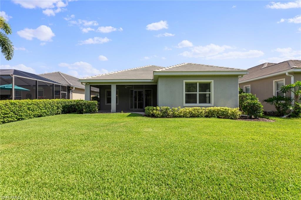 3711 Canopy Circle Naples, FL 34120 - Photo 28 of 28 a front view of house with yard and green space