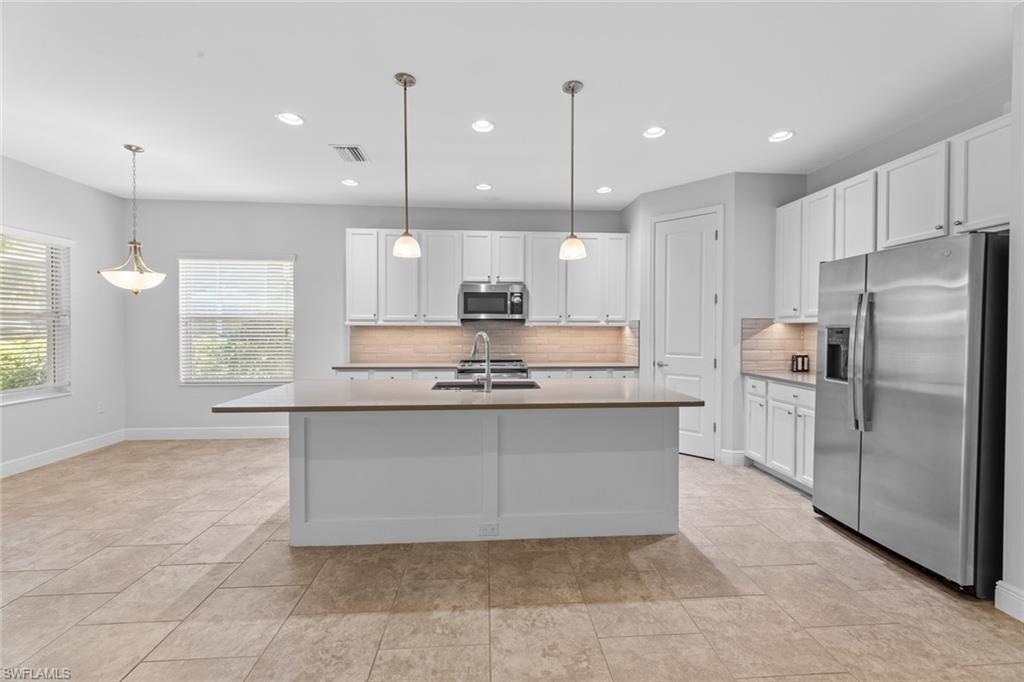 3711 Canopy Circle Naples, FL 34120 - Photo 6 of 28 a large kitchen with a large counter top kitchen appliances and cabinets