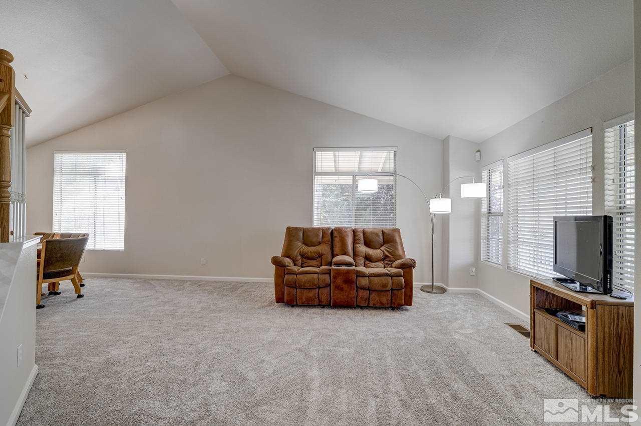9721 Oakley Lane Reno, NV 89521 - Photo 8 of 40 a living room with furniture and a flat screen tv