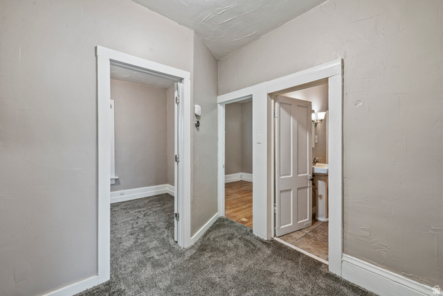 75 600 West Provo, UT 84601 - Photo 14 of 26 Interior hallway featuring neutral wall paint and gray carpet flooring