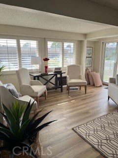 1860 St John Road Seal Beach, CA 90740 - Photo 8 of 10 a living room with furniture large windows and wooden floor