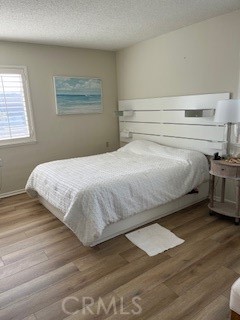 1860 St John Road Seal Beach, CA 90740 - Photo 9 of 10 a bedroom with a bed and a window