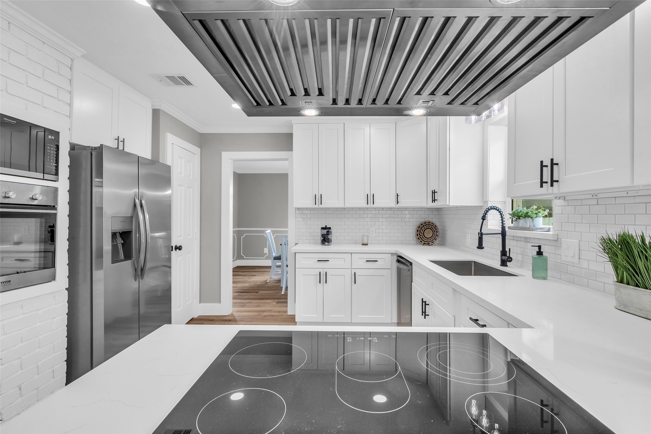 3518 Shore Shadows Drive Crosby, TX 77532 - Photo 11 of 42 a kitchen with stainless steel appliances granite countertop a sink refrigerator and cabinets