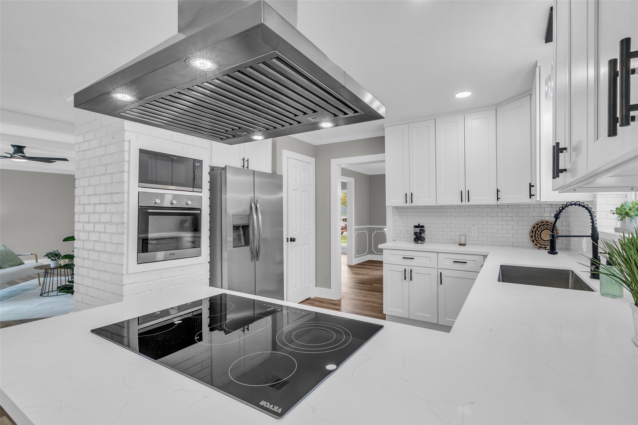 3518 Shore Shadows Drive Crosby, TX 77532 - Photo 12 of 42 a kitchen that has a sink and a stove top oven with wooden floor