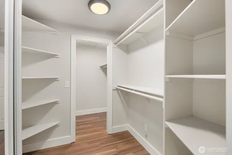 a view of walk in closet with empty racks
