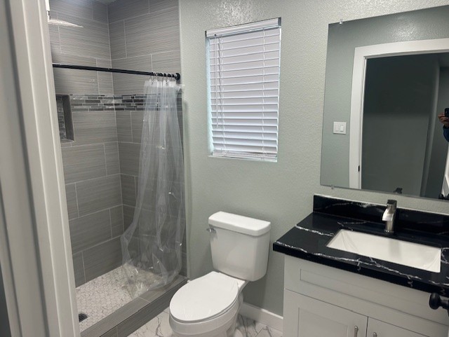 161 South 10th Street, Unit A Conroe, TX 77301 - Photo 14 of 16 a bathroom with a sink a toilet a mirror and shower