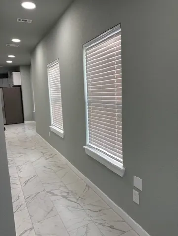 a view of an empty room with a window