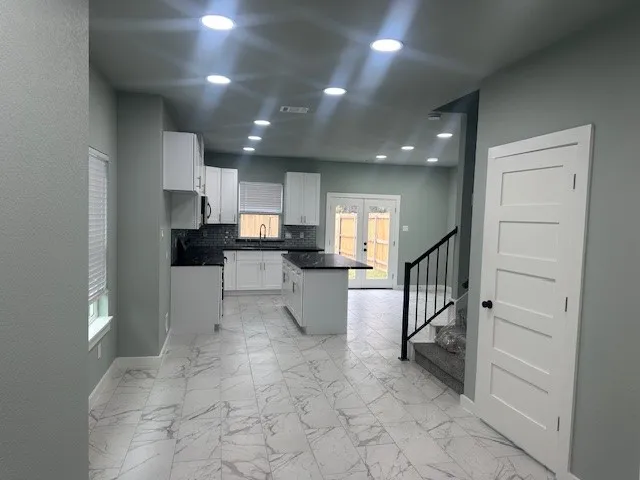 a view of a kitchen with electric appliances
