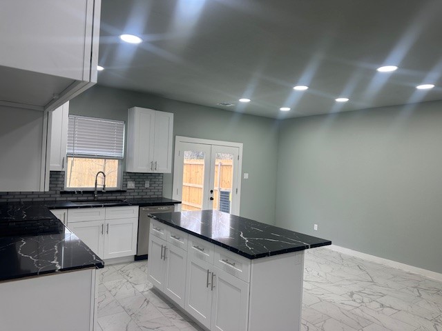 161 South 10th Street, Unit A Conroe, TX 77301 - Photo 4 of 16 a kitchen with granite countertop a sink and cabinets