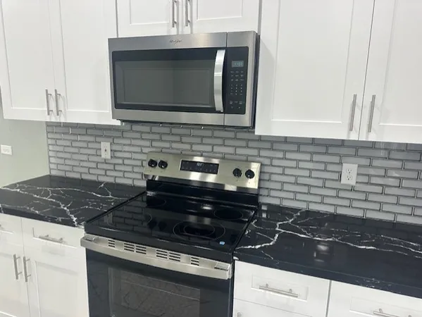 a kitchen with a stove and a microwave