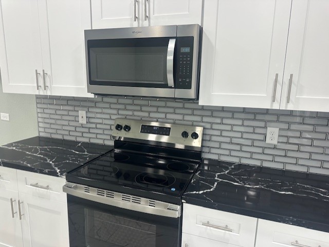 161 South 10th Street, Unit A Conroe, TX 77301 - Photo 6 of 16 a kitchen with a stove and a microwave