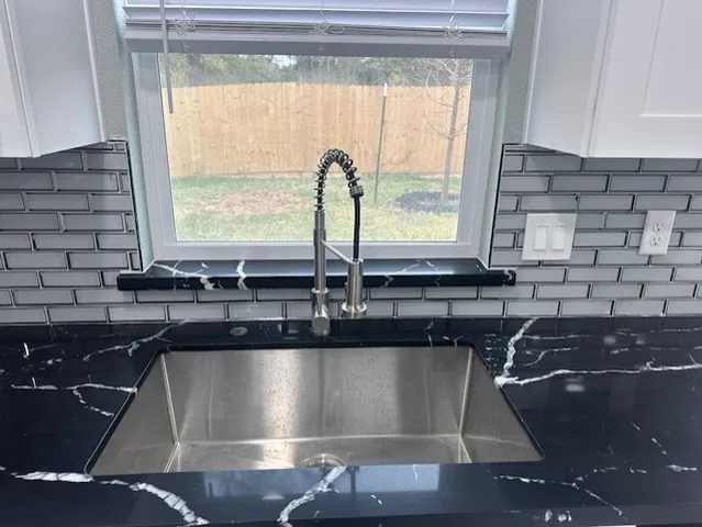 a kitchen with a sink and a window