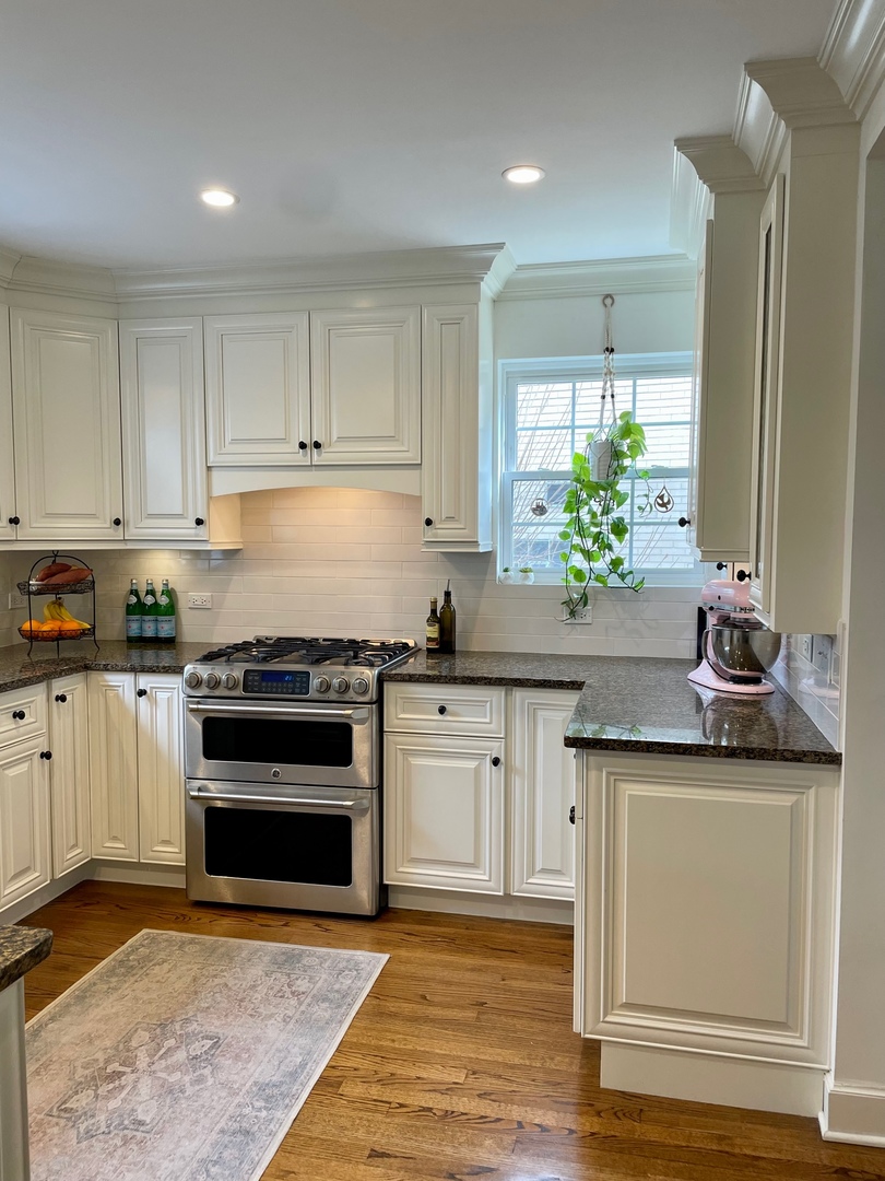 636 Selborne Road Riverside, IL 60546 - Photo 8 of 25 a kitchen with stainless steel appliances granite countertop a stove a sink and a refrigerator
