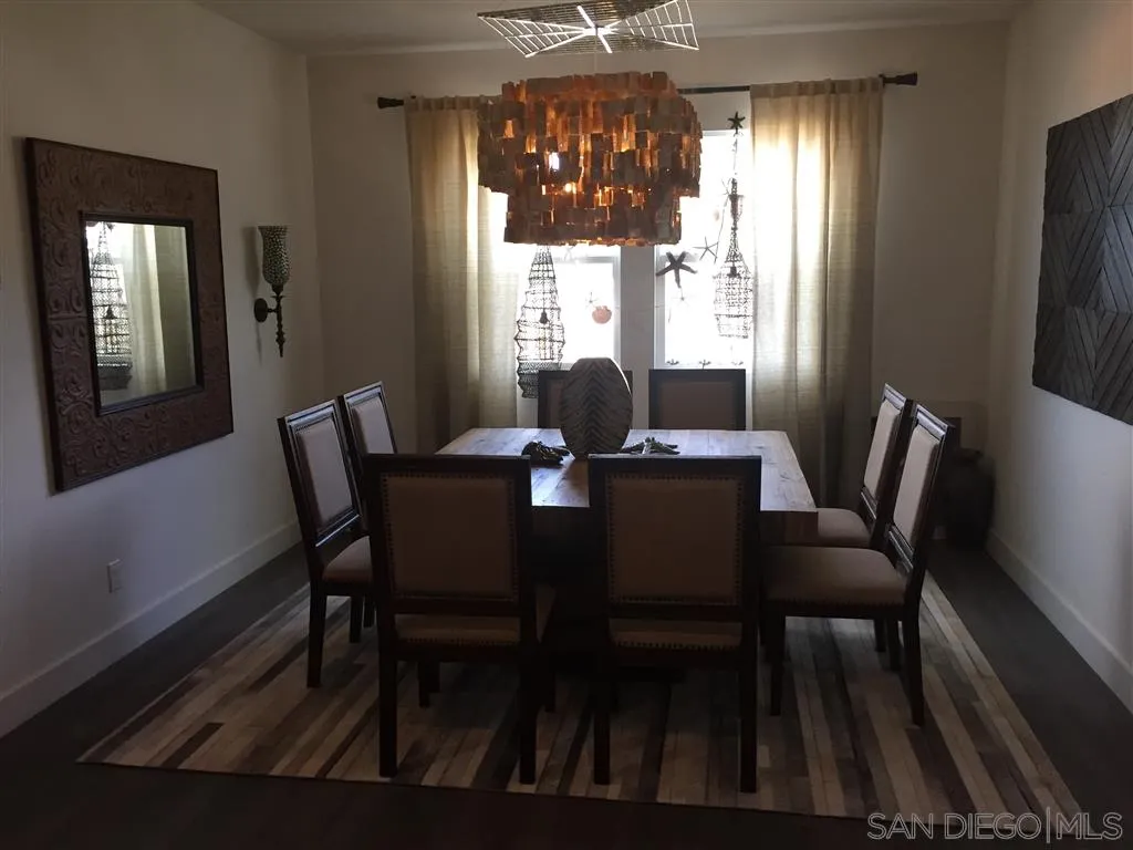 672 Polaris Drive Encinitas, CA 92024 - Photo 16 of 26 a view of a dining room with furniture wooden floor and chandelier