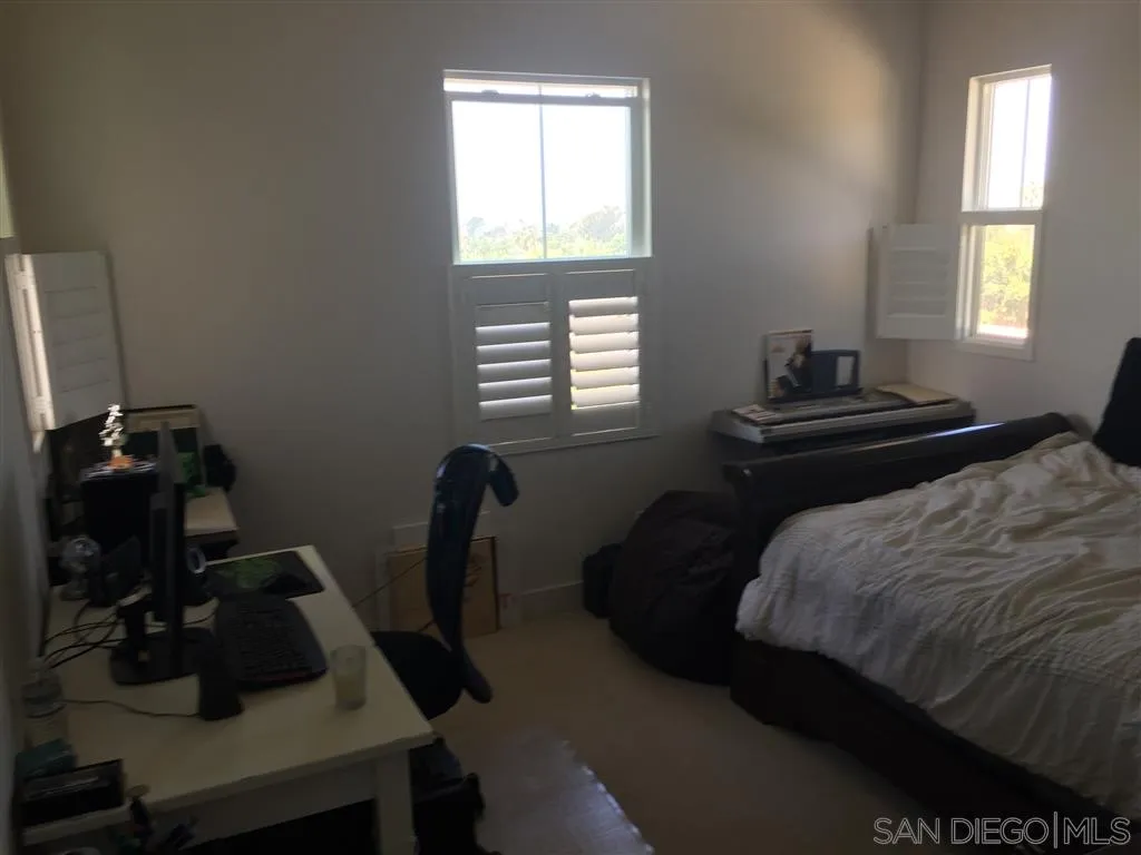 672 Polaris Drive Encinitas, CA 92024 - Photo 21 of 26 a bedroom with a bed and a window