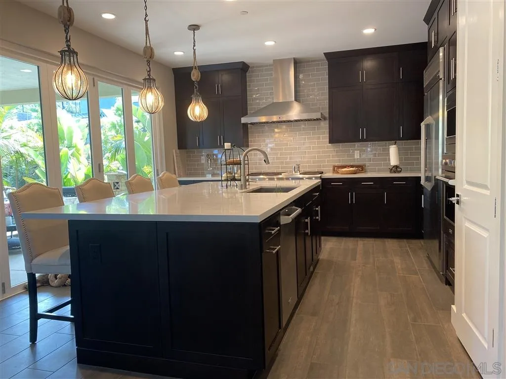 672 Polaris Drive Encinitas, CA 92024 - Photo 7 of 26 a large kitchen with kitchen island granite countertop a sink counter space appliances and a large window