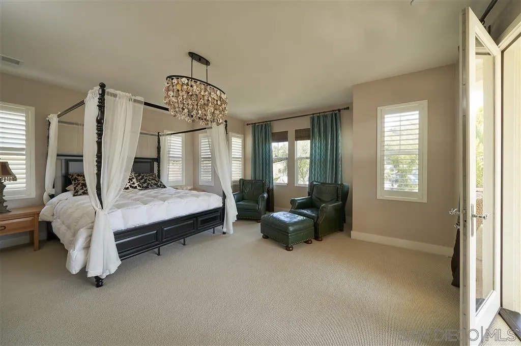 672 Polaris Drive Encinitas, CA 92024 - Photo 8 of 26 a spacious bedroom with a bed couch and window