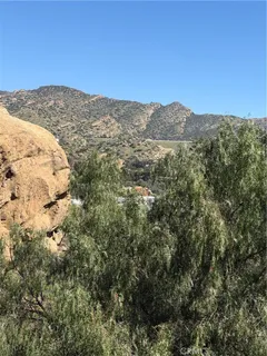 a view of a mountain range in a cloudy sky
