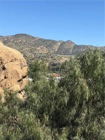 a view of a mountain range in a cloudy sky