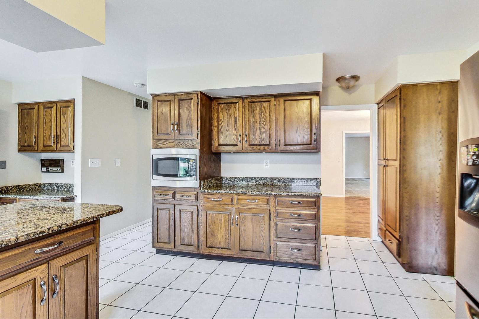 311 Deerpath Drive Winthrop Harbor, IL 60096 - Photo 11 of 48 a kitchen with stainless steel appliances granite countertop a stove a sink and a refrigerator