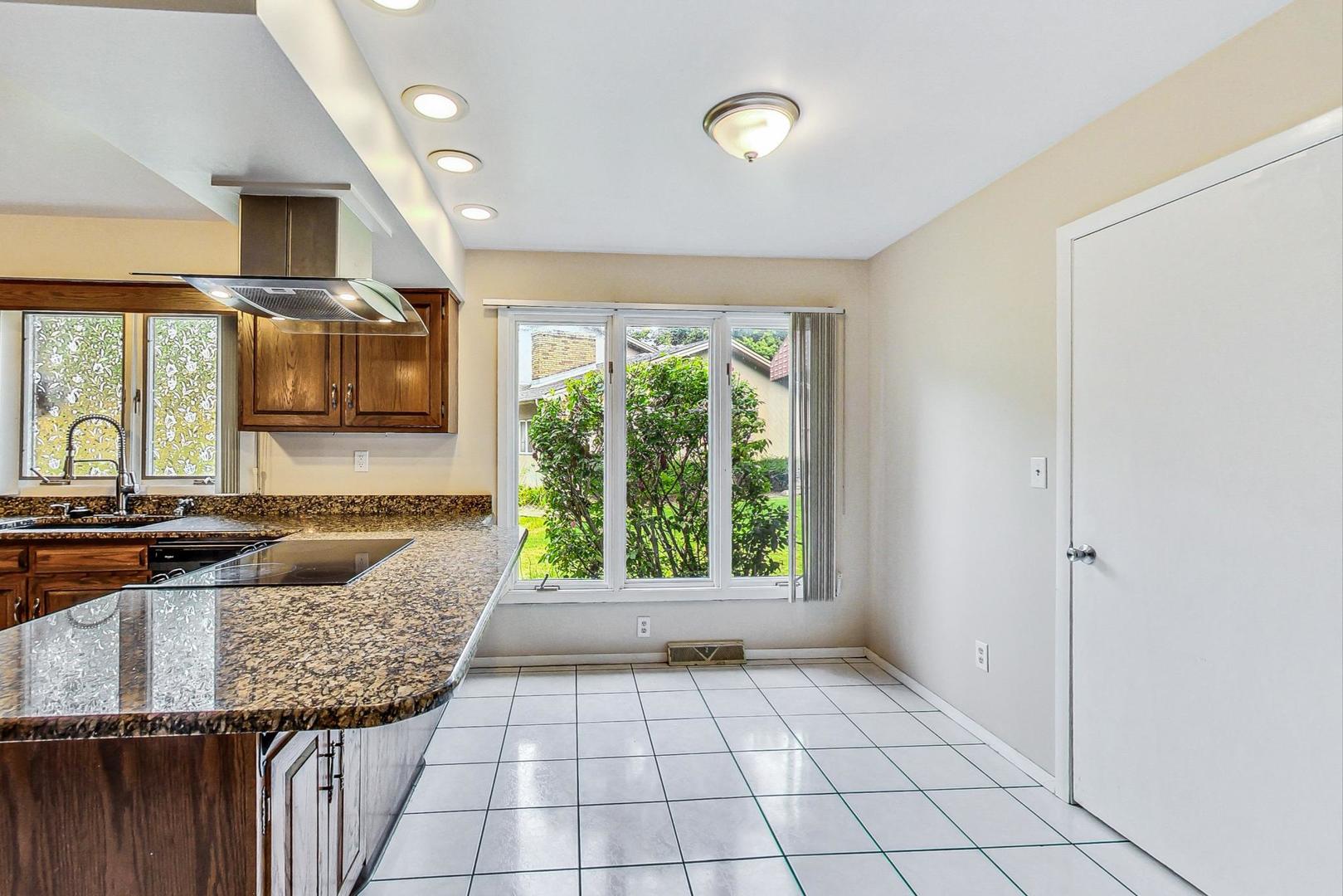311 Deerpath Drive Winthrop Harbor, IL 60096 - Photo 12 of 48 a living room with granite countertop furniture and a floor to ceiling window