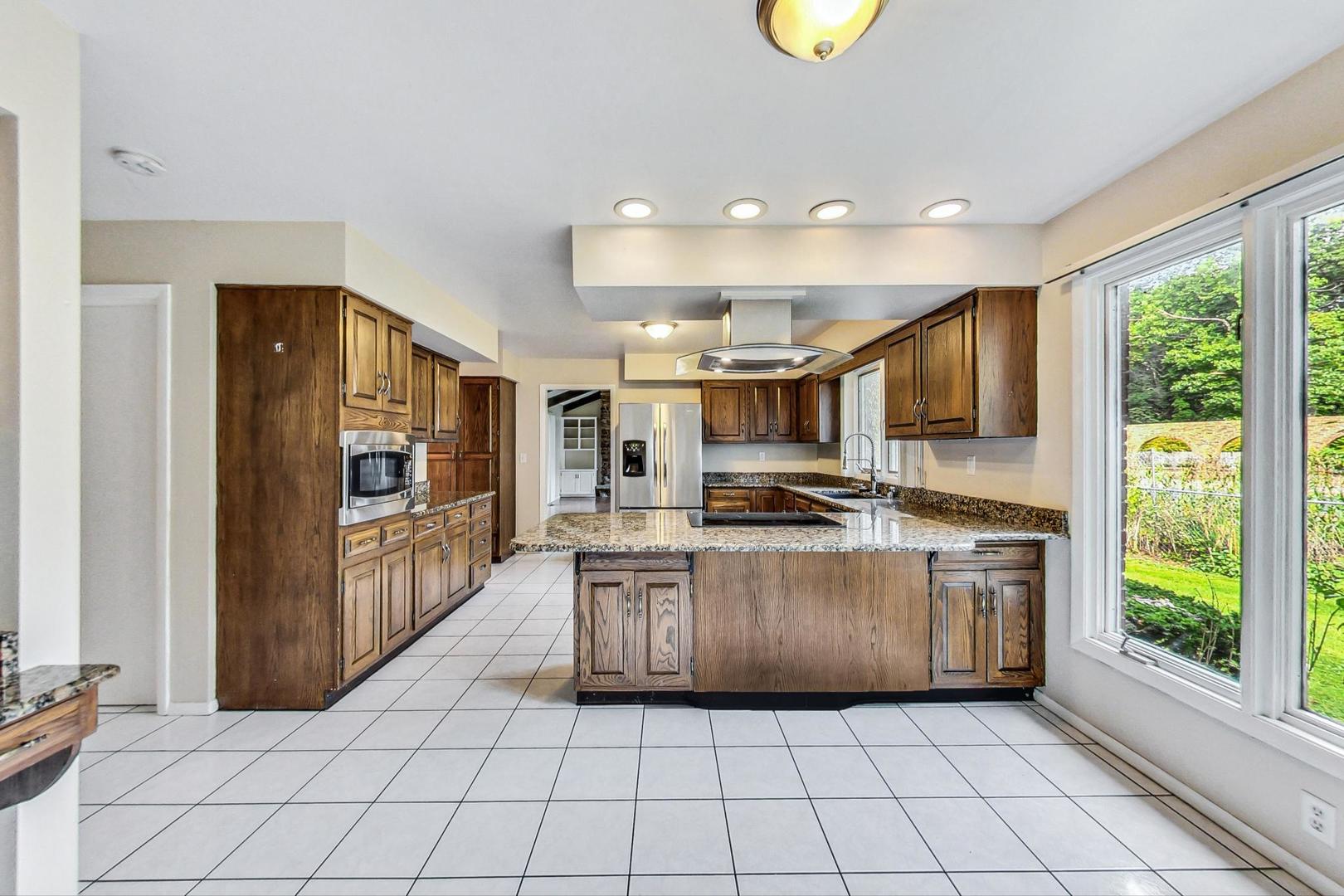 311 Deerpath Drive Winthrop Harbor, IL 60096 - Photo 13 of 48 a large kitchen with stainless steel appliances granite countertop a stove and a refrigerator