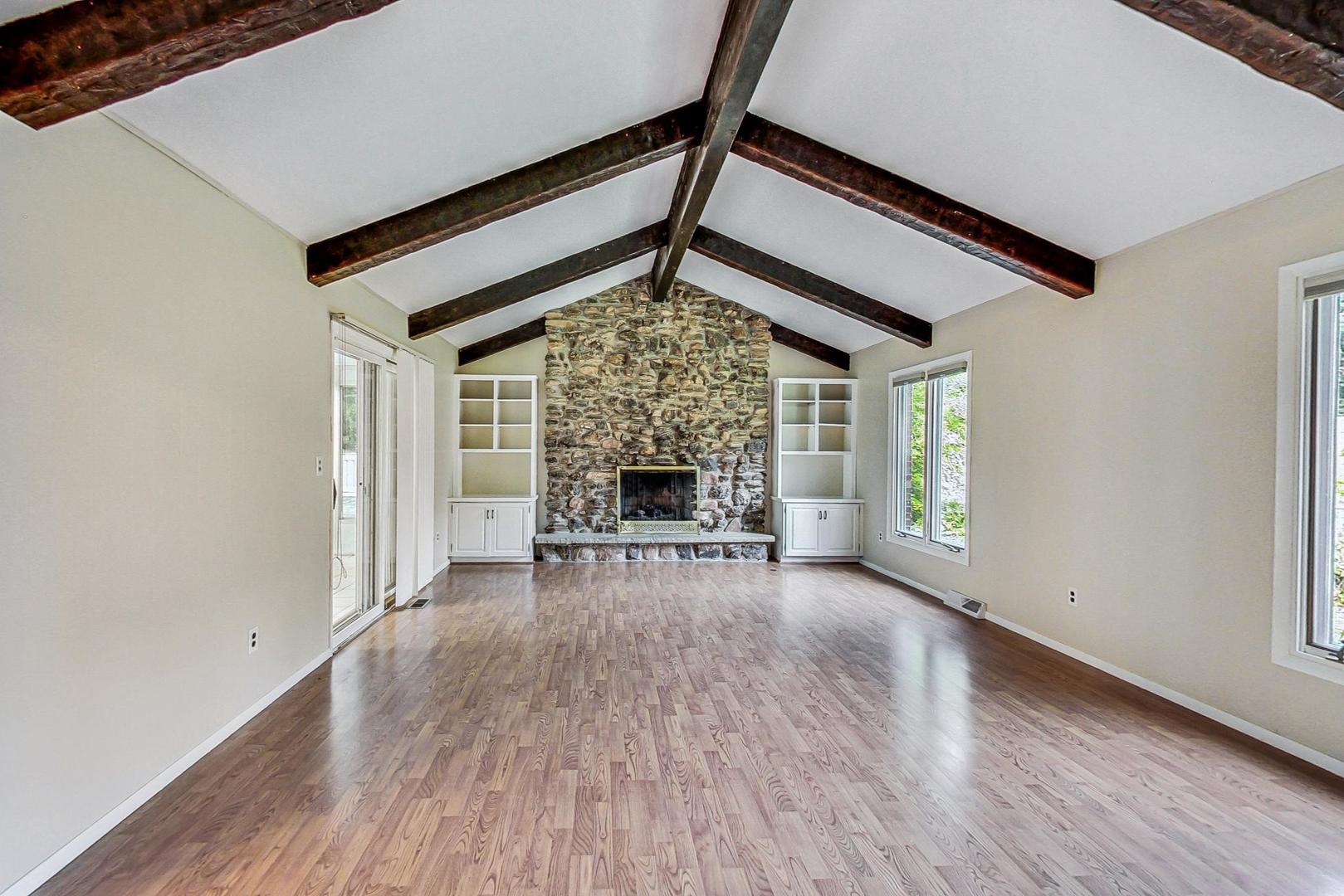 311 Deerpath Drive Winthrop Harbor, IL 60096 - Photo 15 of 48 an empty room with wooden floor fireplace and windows