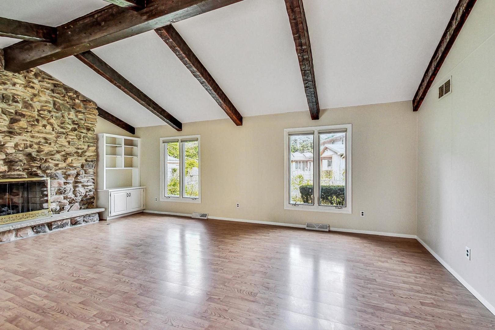 311 Deerpath Drive Winthrop Harbor, IL 60096 - Photo 16 of 48 a view of an empty room with wooden floor and a window